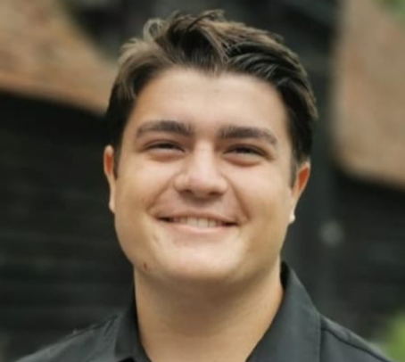 This image contains a picture of Kyriakos (Kai) Dodson